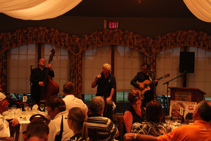 Entertaining the crowd after a fun day golfing,  singer John McDermott had the crowd tapping and clapping  accompanied by bassist George Koller, left, and Jason Fowler.